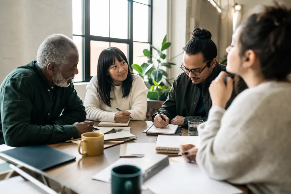 Community advocates drafting talking points together at a co-working space table